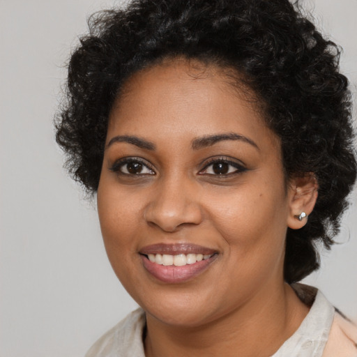 Joyful black young-adult female with medium  brown hair and brown eyes