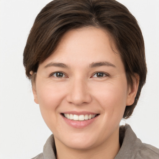 Joyful white young-adult female with medium  brown hair and brown eyes