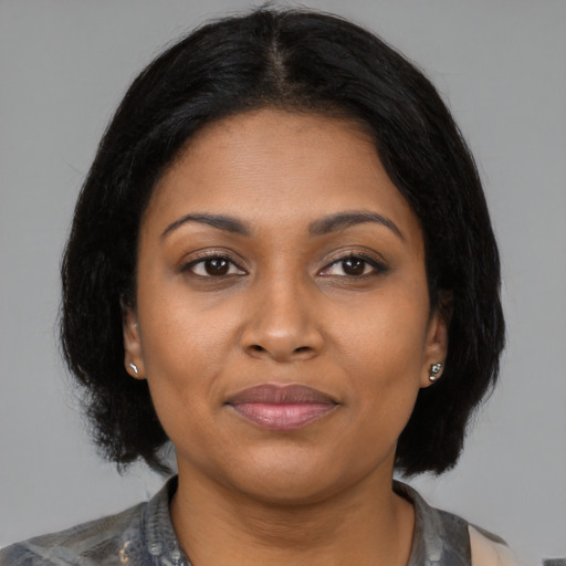 Joyful black young-adult female with medium  brown hair and brown eyes