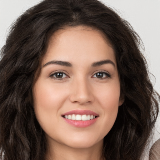 Joyful white young-adult female with long  brown hair and brown eyes