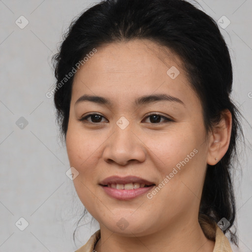 Joyful latino young-adult female with medium  brown hair and brown eyes