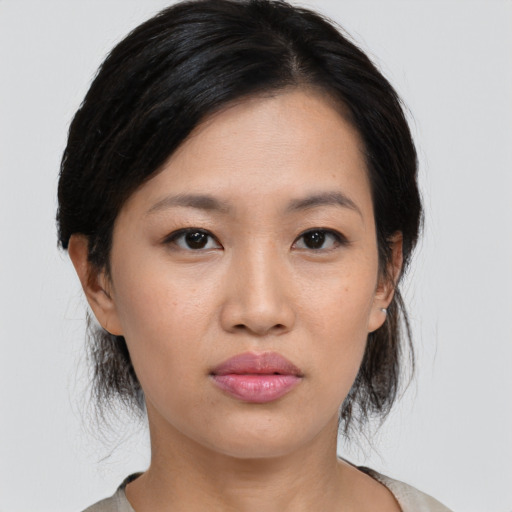 Joyful asian young-adult female with medium  black hair and brown eyes