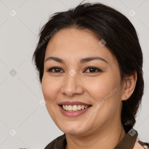 Joyful white adult female with medium  brown hair and brown eyes