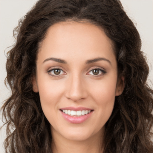 Joyful white young-adult female with long  brown hair and brown eyes