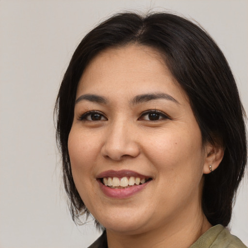 Joyful asian young-adult female with medium  brown hair and brown eyes