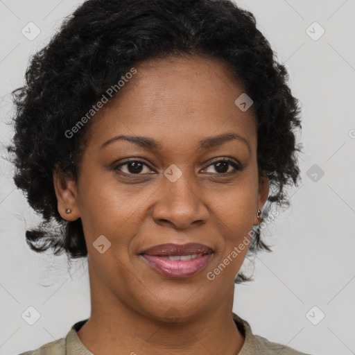 Joyful black adult female with short  brown hair and brown eyes