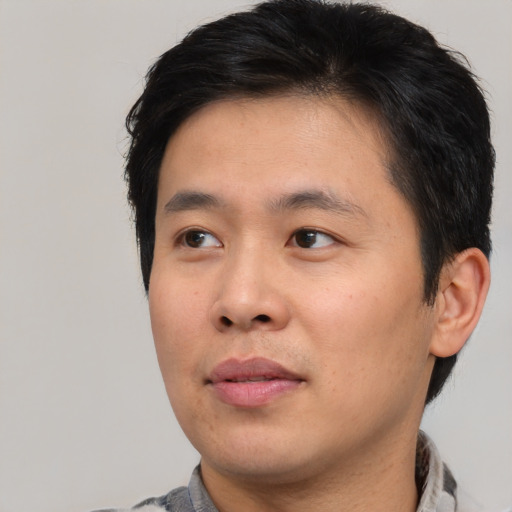 Neutral asian young-adult male with short  brown hair and brown eyes