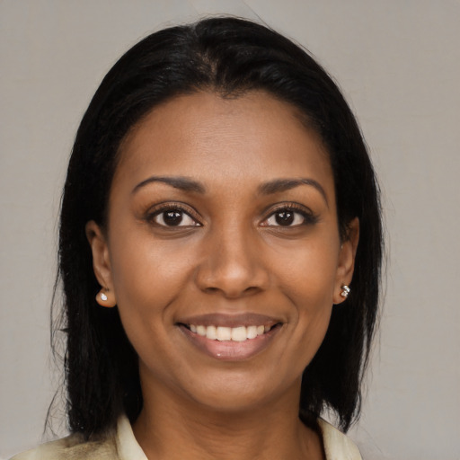Joyful black young-adult female with medium  brown hair and brown eyes