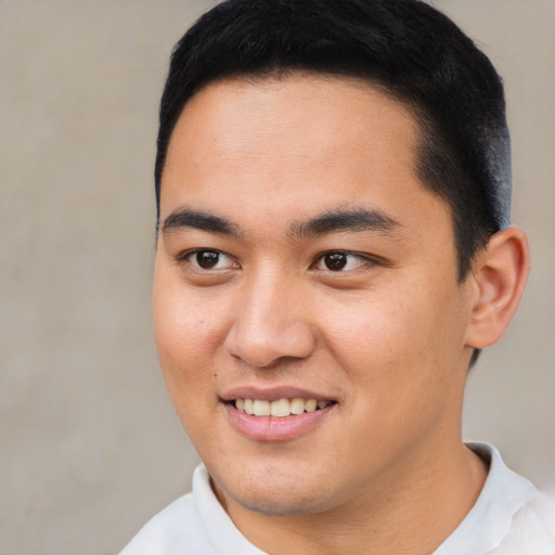 Joyful asian young-adult male with short  brown hair and brown eyes