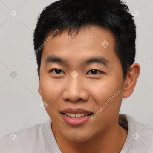 Joyful asian young-adult male with short  black hair and brown eyes