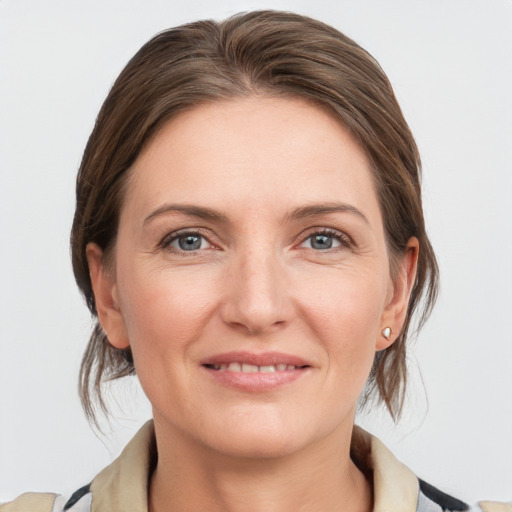 Joyful white young-adult female with medium  brown hair and grey eyes