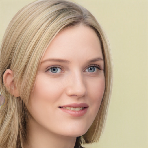 Joyful white young-adult female with long  blond hair and blue eyes