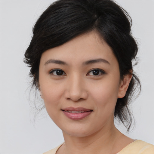 Joyful asian young-adult female with medium  brown hair and brown eyes
