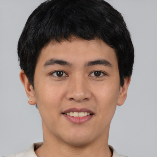 Joyful asian young-adult male with short  brown hair and brown eyes