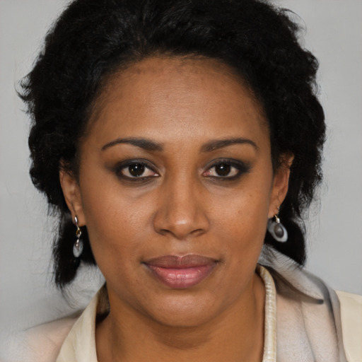 Joyful black young-adult female with medium  brown hair and brown eyes