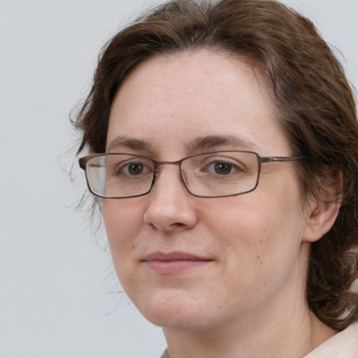 Joyful white adult female with medium  brown hair and grey eyes