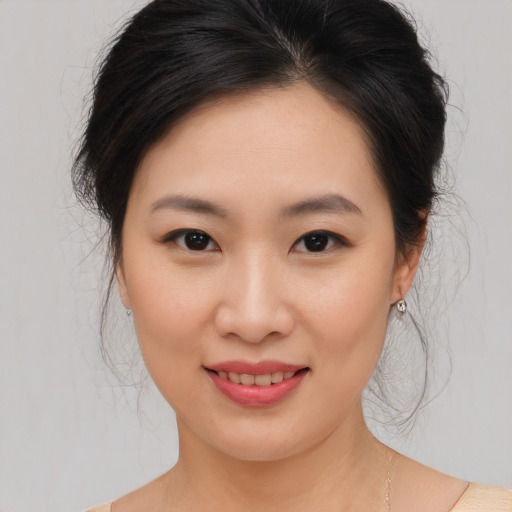 Joyful asian young-adult female with medium  brown hair and brown eyes