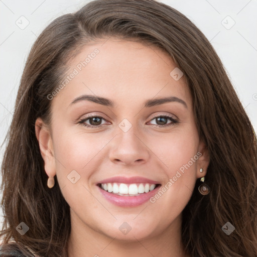 Joyful white young-adult female with long  brown hair and grey eyes