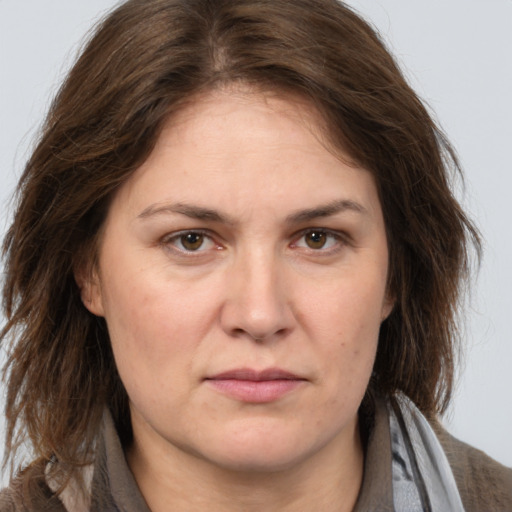 Joyful white adult female with long  brown hair and brown eyes