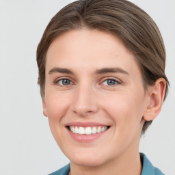 Joyful white young-adult female with short  brown hair and grey eyes