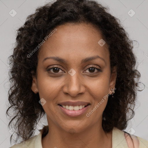 Joyful black young-adult female with long  brown hair and brown eyes