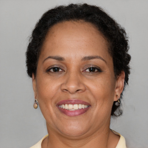 Joyful black adult female with short  brown hair and brown eyes