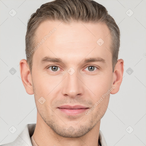 Joyful white young-adult male with short  brown hair and grey eyes