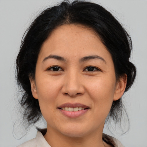 Joyful asian young-adult female with medium  brown hair and brown eyes