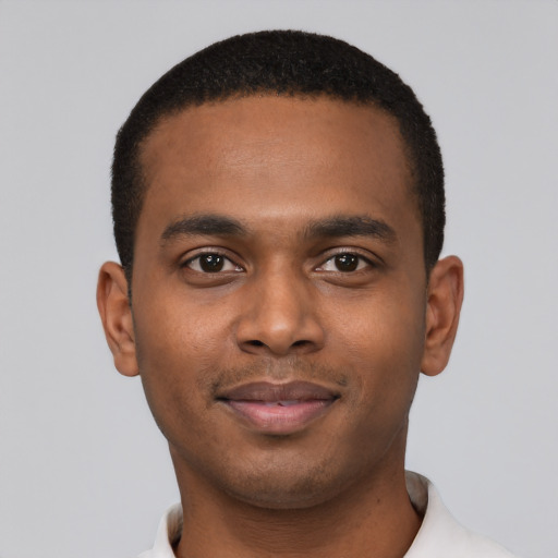 Joyful black young-adult male with short  black hair and brown eyes