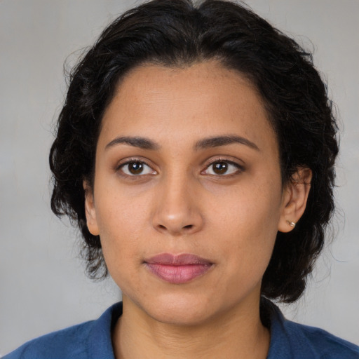 Joyful latino young-adult female with medium  black hair and brown eyes