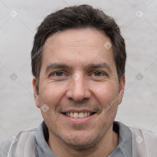 Joyful white adult male with short  brown hair and brown eyes