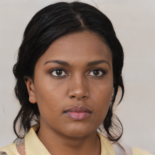 Neutral black young-adult female with medium  brown hair and brown eyes