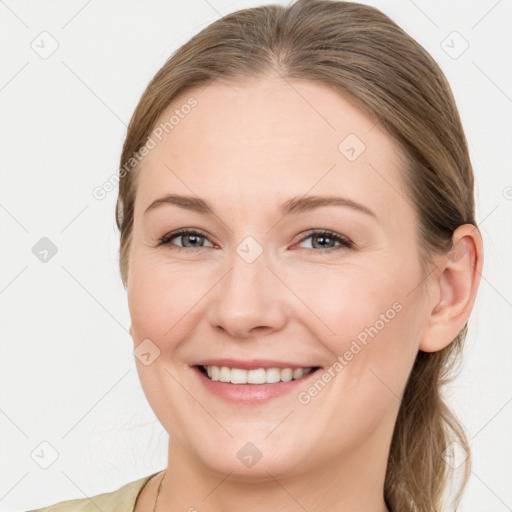 Joyful white young-adult female with long  brown hair and blue eyes