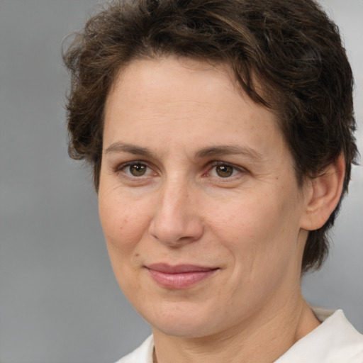 Joyful white adult female with short  brown hair and brown eyes