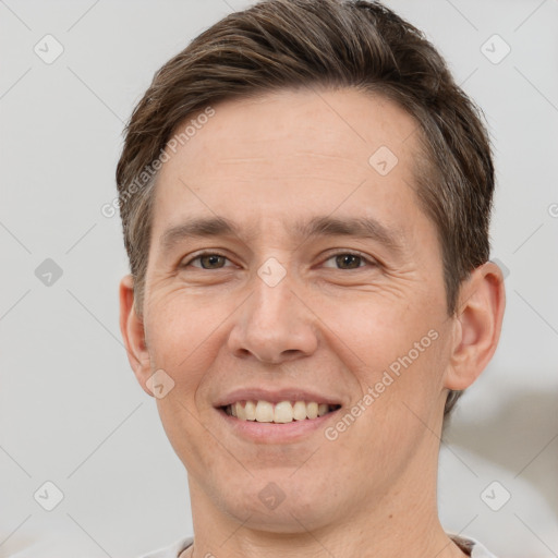 Joyful white adult male with short  brown hair and brown eyes