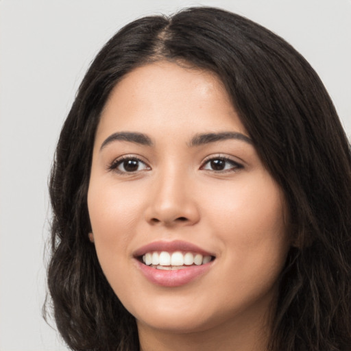 Joyful latino young-adult female with long  black hair and brown eyes