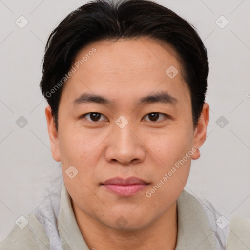 Joyful asian young-adult male with short  brown hair and brown eyes