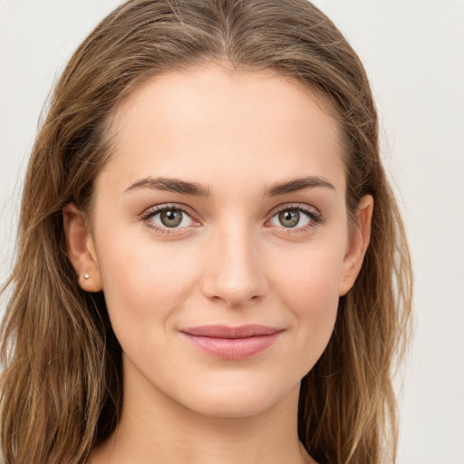 Joyful white young-adult female with long  brown hair and green eyes