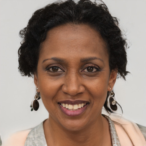 Joyful black adult female with short  brown hair and brown eyes