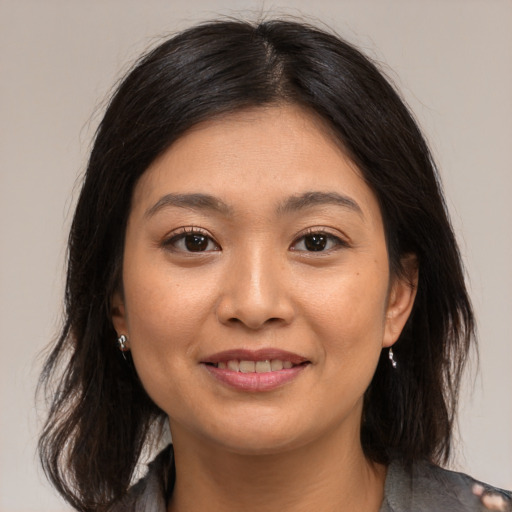 Joyful asian young-adult female with medium  brown hair and brown eyes