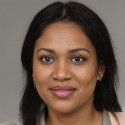 Joyful black young-adult female with medium  brown hair and brown eyes