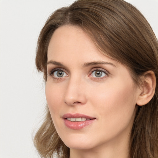 Joyful white young-adult female with long  brown hair and blue eyes