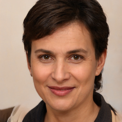 Joyful white adult female with short  brown hair and brown eyes