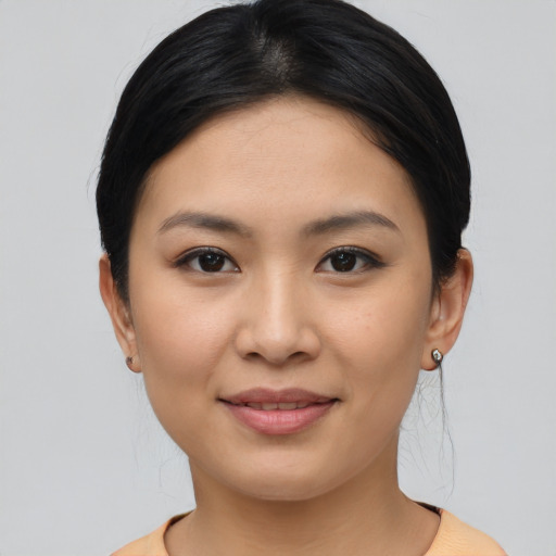 Joyful asian young-adult female with medium  brown hair and brown eyes