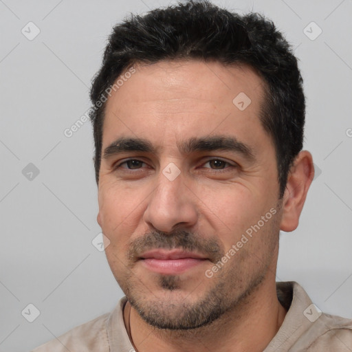 Joyful white young-adult male with short  black hair and brown eyes