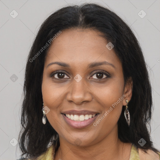 Joyful black young-adult female with long  brown hair and brown eyes