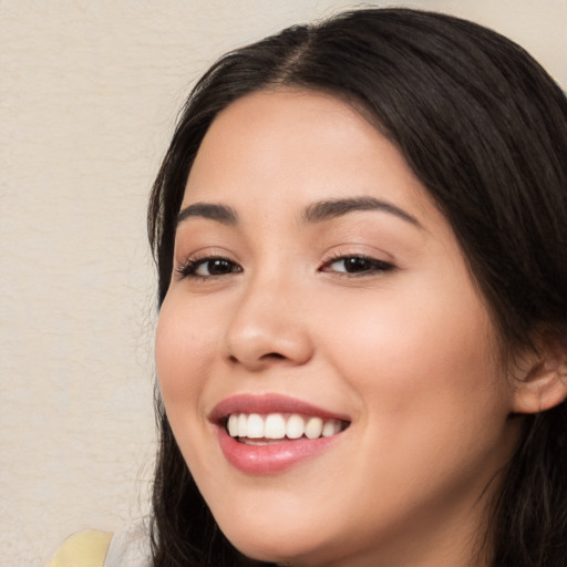 Joyful white young-adult female with long  black hair and brown eyes