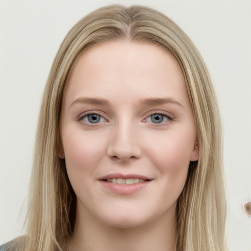 Joyful white young-adult female with long  brown hair and blue eyes