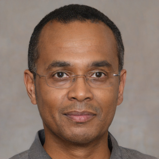 Joyful latino adult male with short  black hair and brown eyes