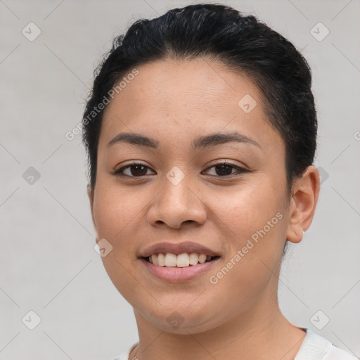 Joyful latino young-adult female with short  brown hair and brown eyes